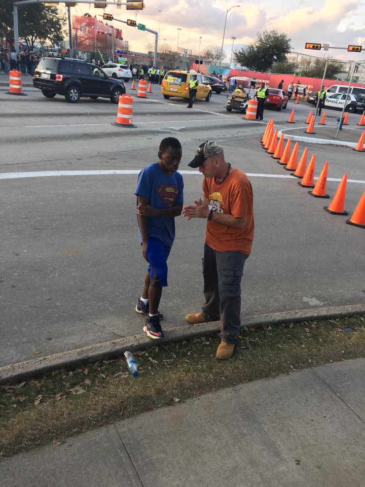 Doc leading a young boy to Christ